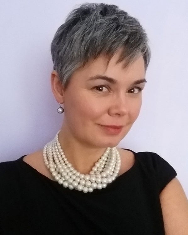 image of pretty woman with gray pixie cut wearing pearls and black dress pearls