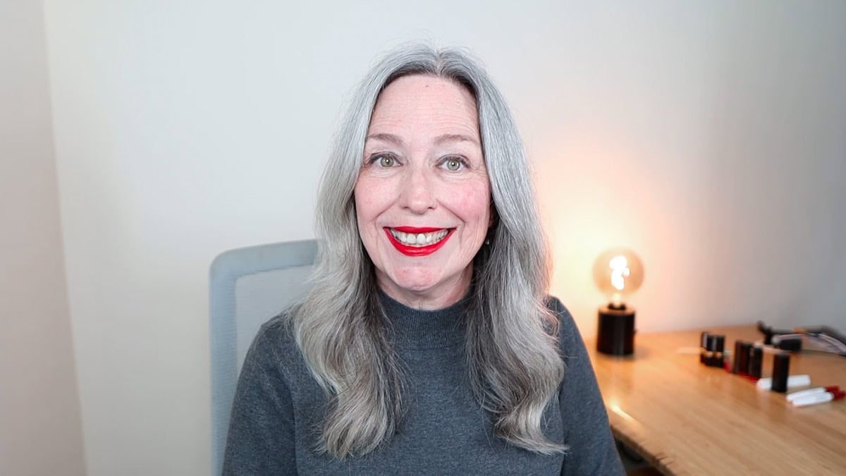 image of woman with long gray hair wearing Mac Ruby Woo lipstick