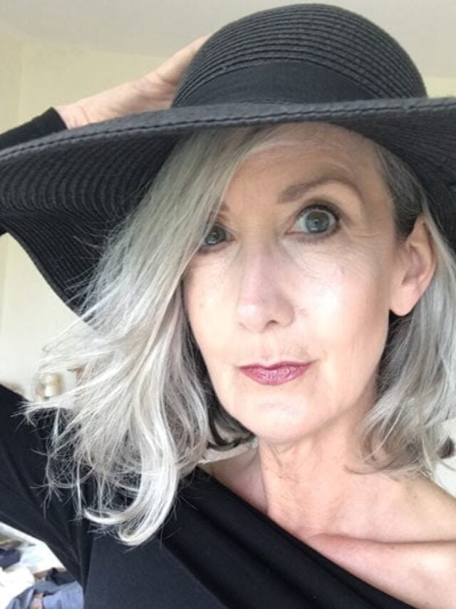 image of woman long gray hair black hat
