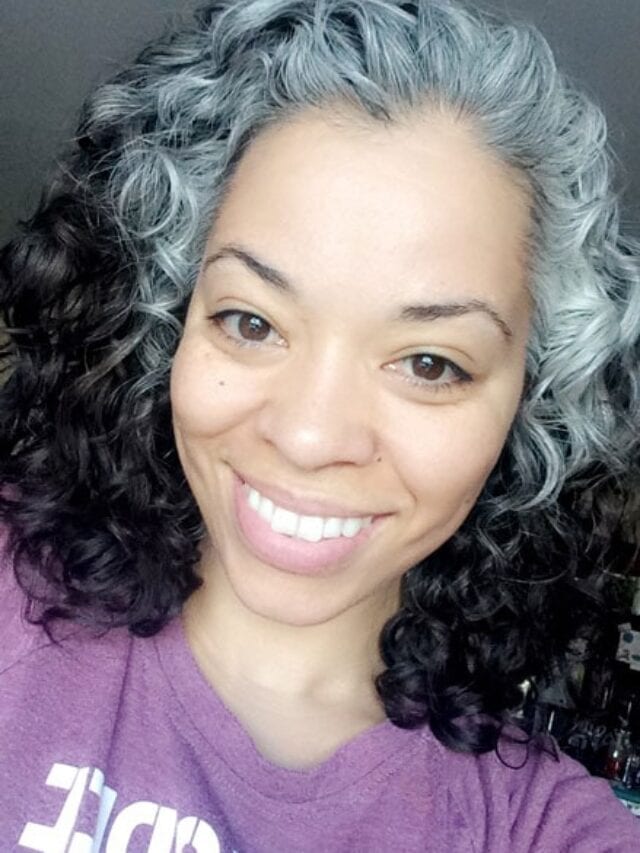 image of beautiful black woman who is transitioning to gray curly hair