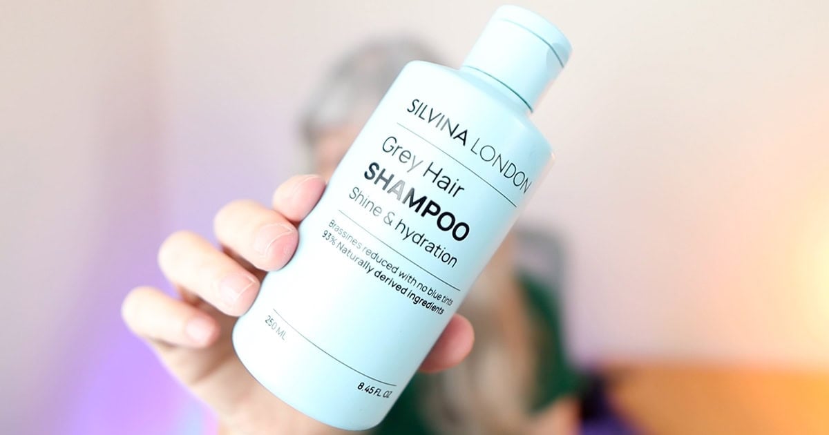 image of katie holding up her bottle of silvina london grey hair shampoo