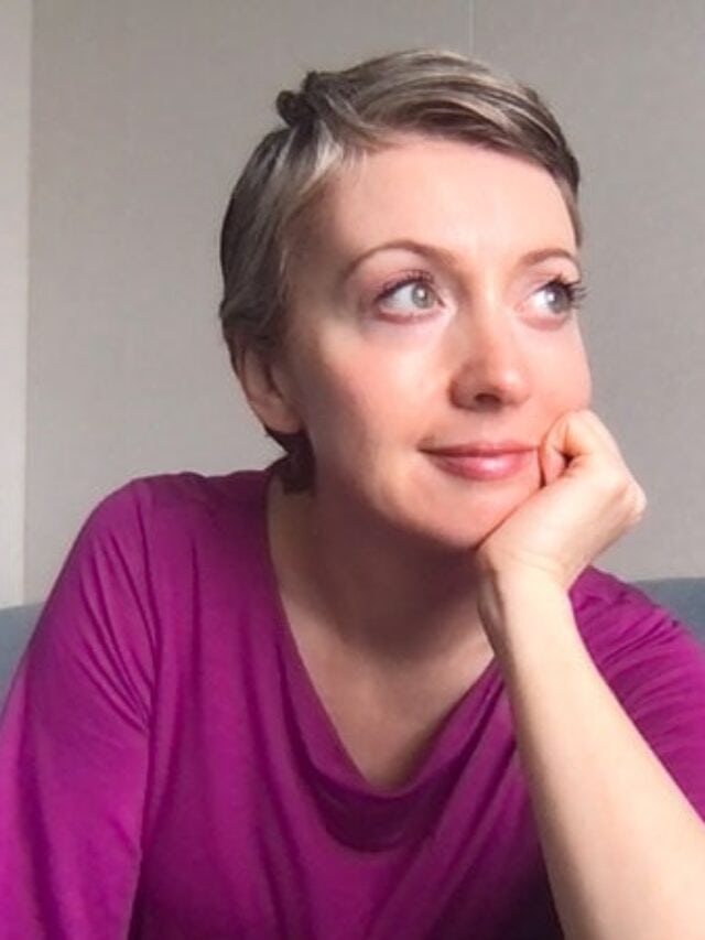 image of woman with pink shirt and short gray hair