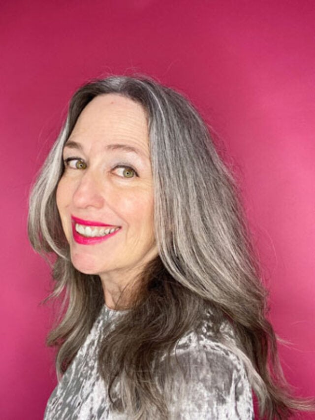 image of woman with gray hair on pink background