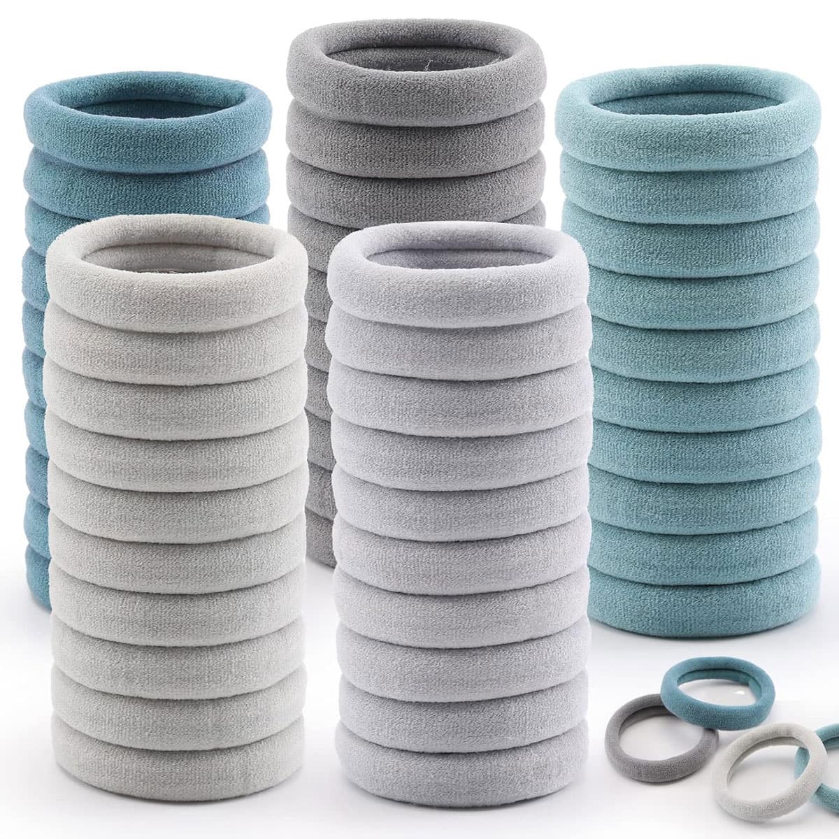 stacks of seamless hair ties in various shades of blue and gray stacked up against a white background