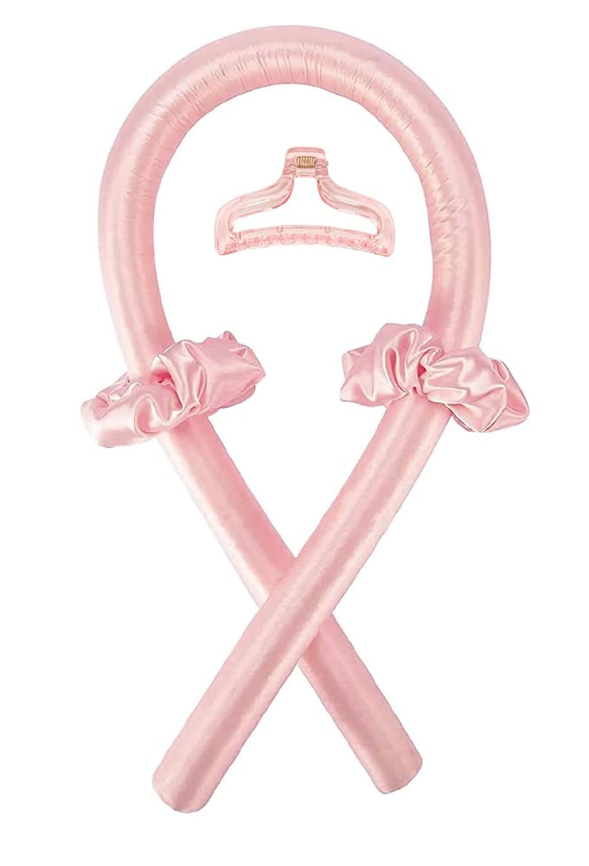 pink curling ribbon, two pink scrunchies, and a pink claw clip against a white background