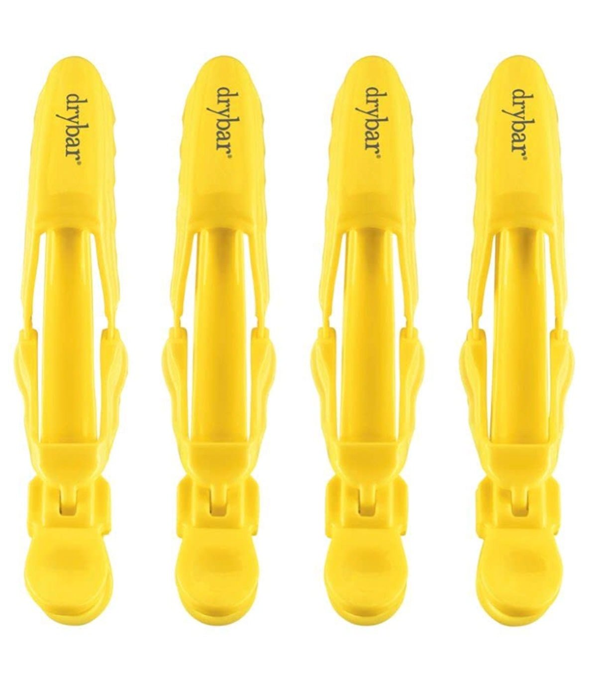 4 yellow hair clips against a white background