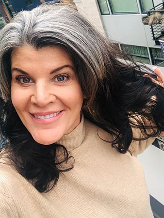 image of woman with gray roots and dark brunette ends