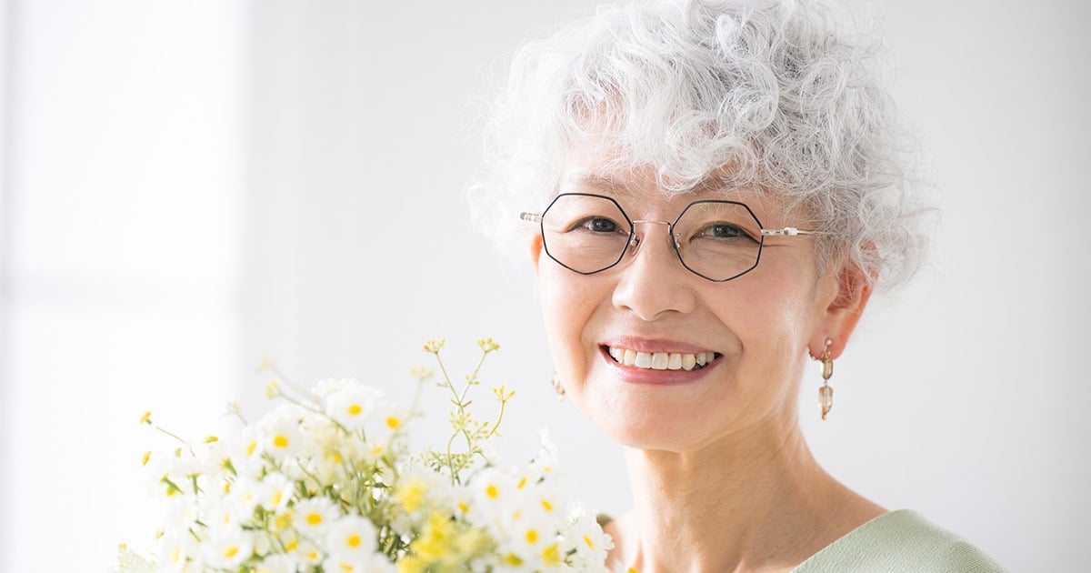 attractive older Asian lady with white curly hair