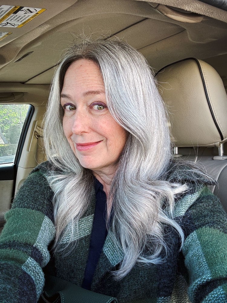 image of Katie in her car seat with green sweater