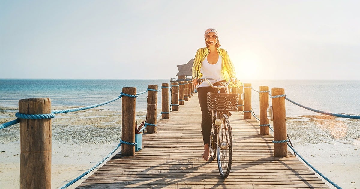 image of woman riding bicycle on pier