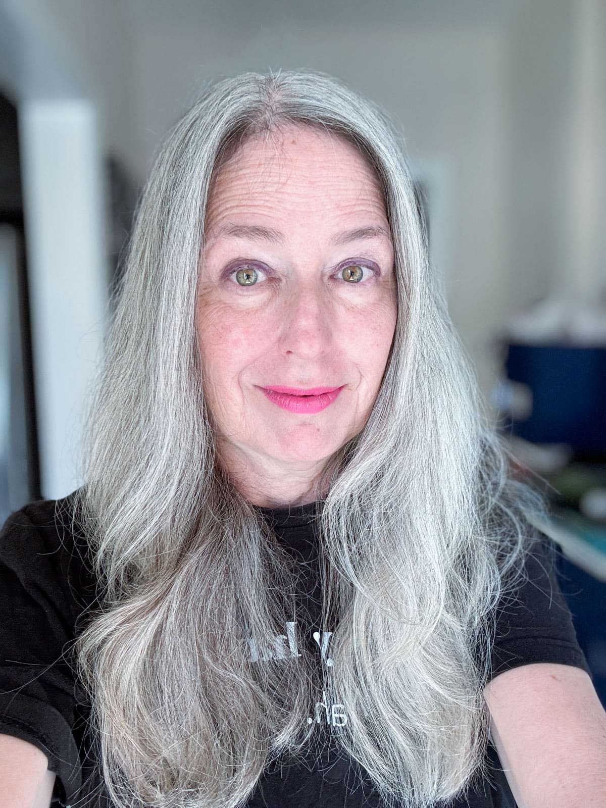 image of Katie - woman with long gray hair in black tshirt