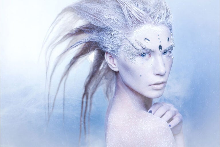 snow queen woman with frozen hair and glitter makeup halloween costume for gray-haired woman