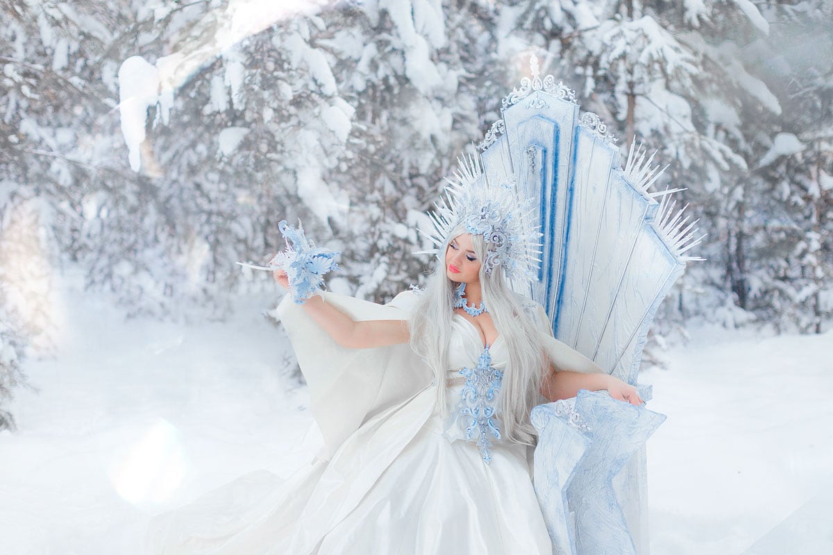 image of a beautiful woman dressed as a Snow Queen in a snowy landscape