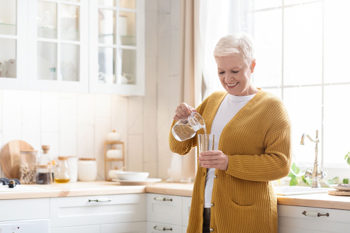 image of woman with white hair pouring water