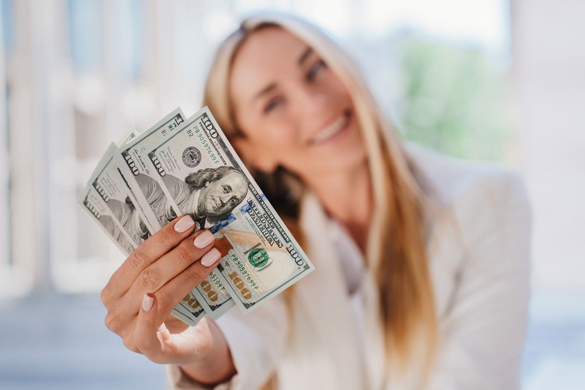 image of woman holding money
