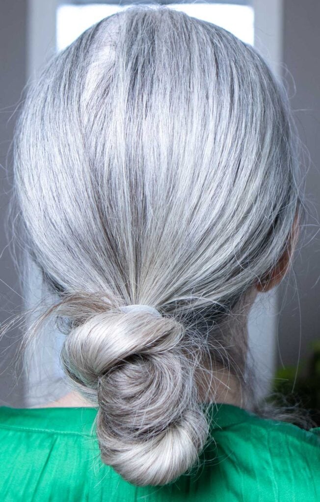 image of the back of a gray-haired woman's head showing bald spot covered by white powder