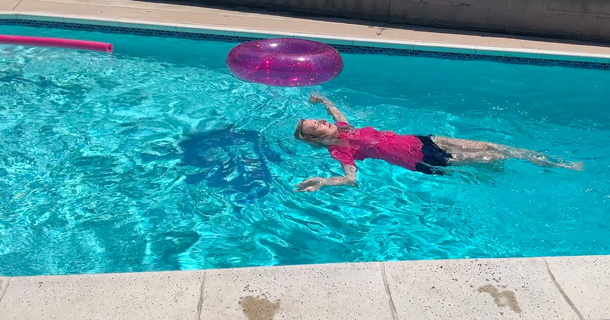image of katie in pool with gray hair getting wet