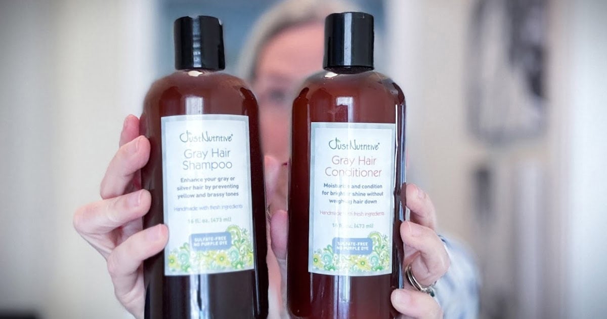 image of katie holding just nutritive gray hair shampoo and conditioner bottles