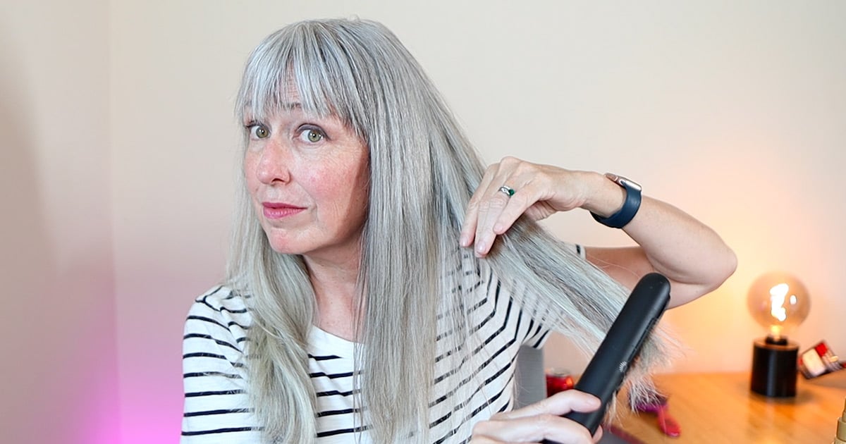 image of katie flat ironing one section of her gray hair