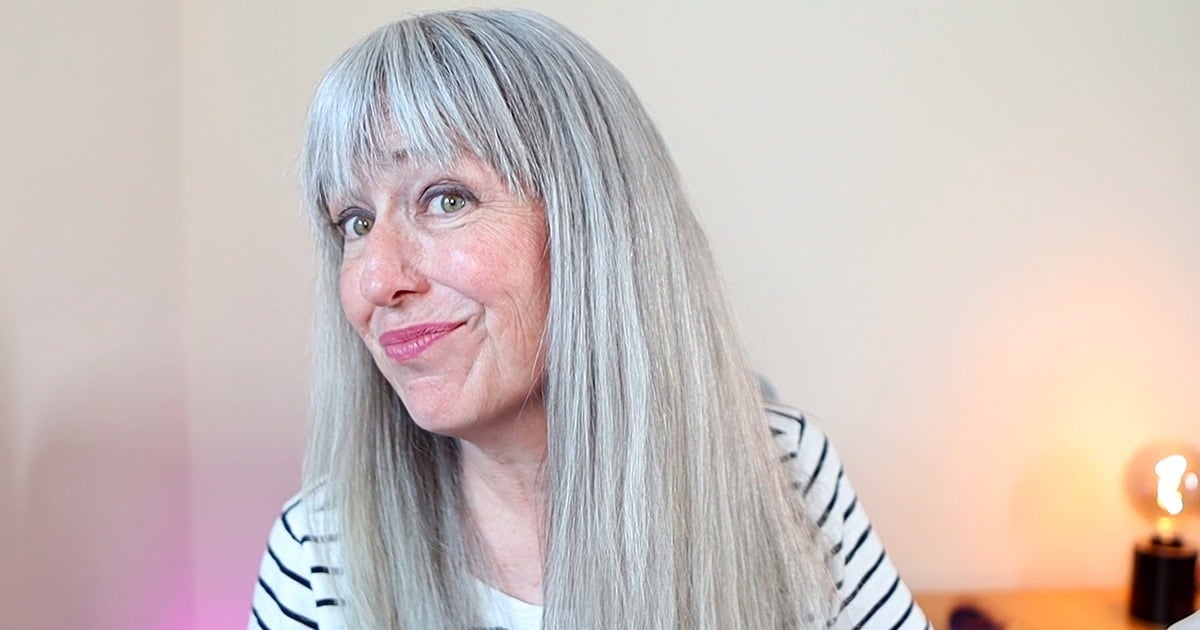 image of katie with very sleek gray hair with bangs smiling