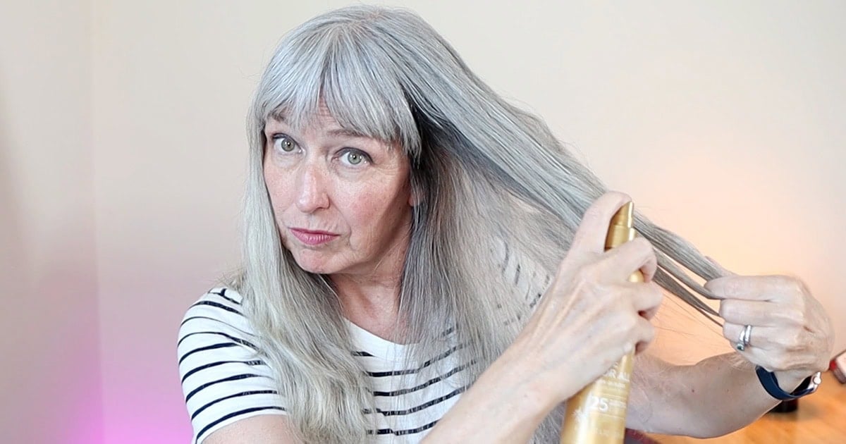 image of katie spraying thermal protectant on hair